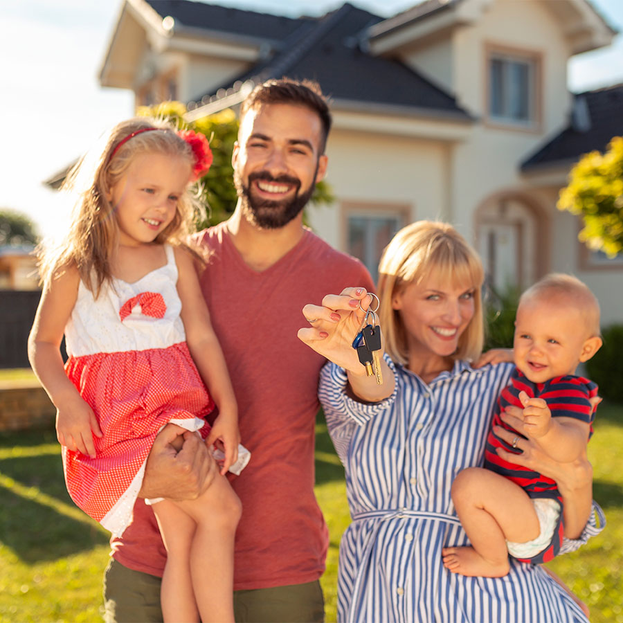 Picture of a family holding the keys to a house.